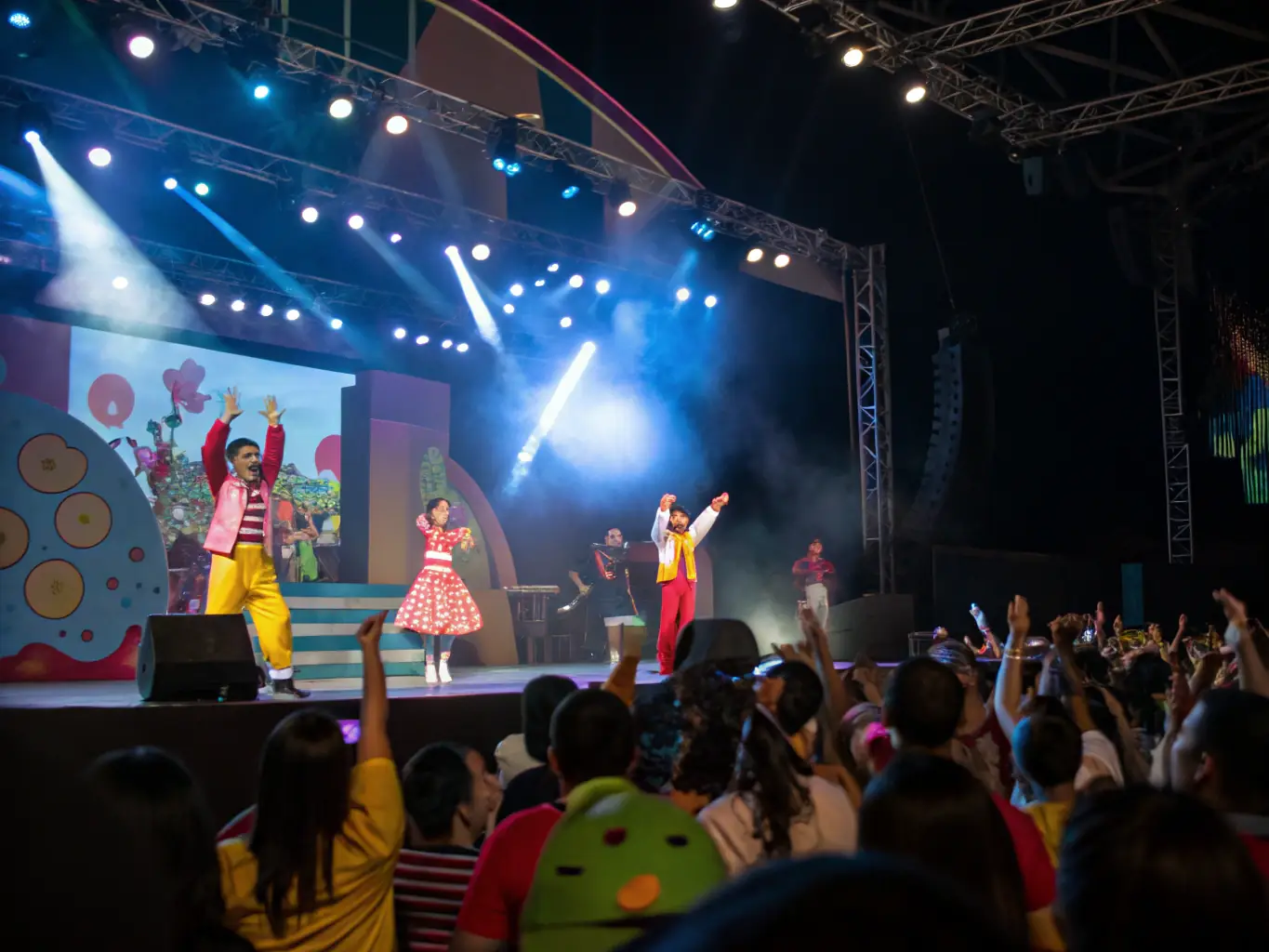 A vibrant image of performers executing acrobatic acts on an urban stage, with a lively crowd in the background, showcasing the energy and excitement of BETON BRUME's urban circus performances.